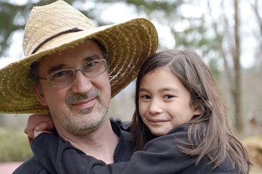 A man and girl are smiling for the camera.