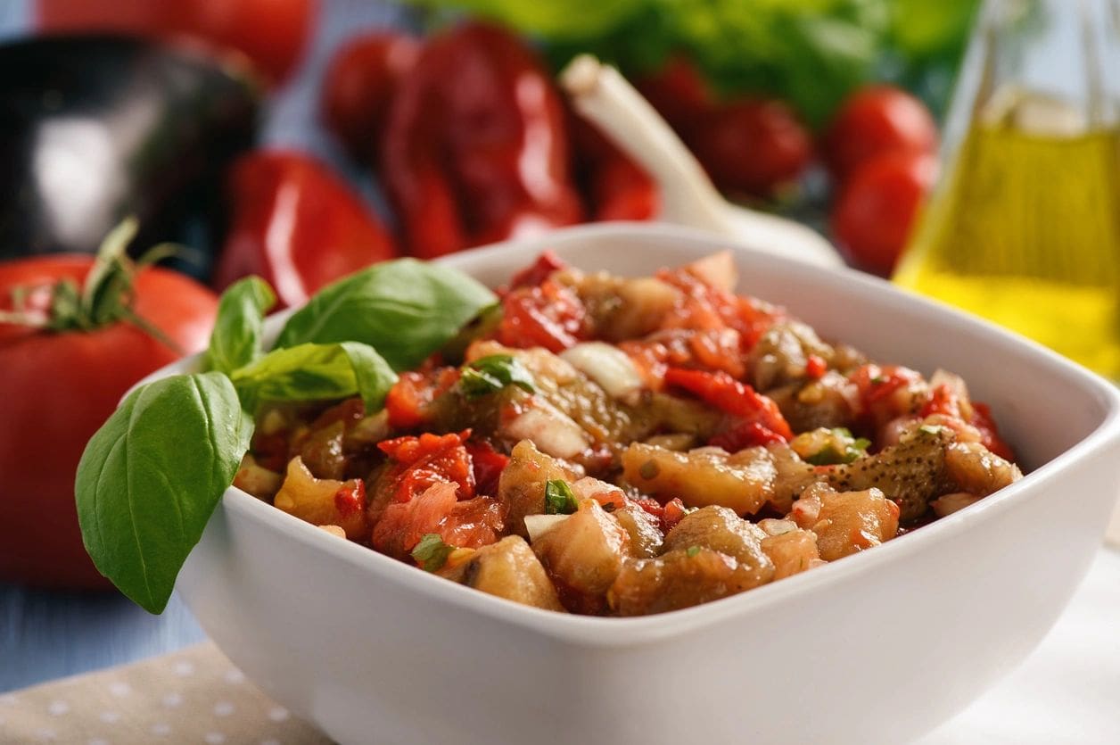 A bowl of food with some vegetables in it