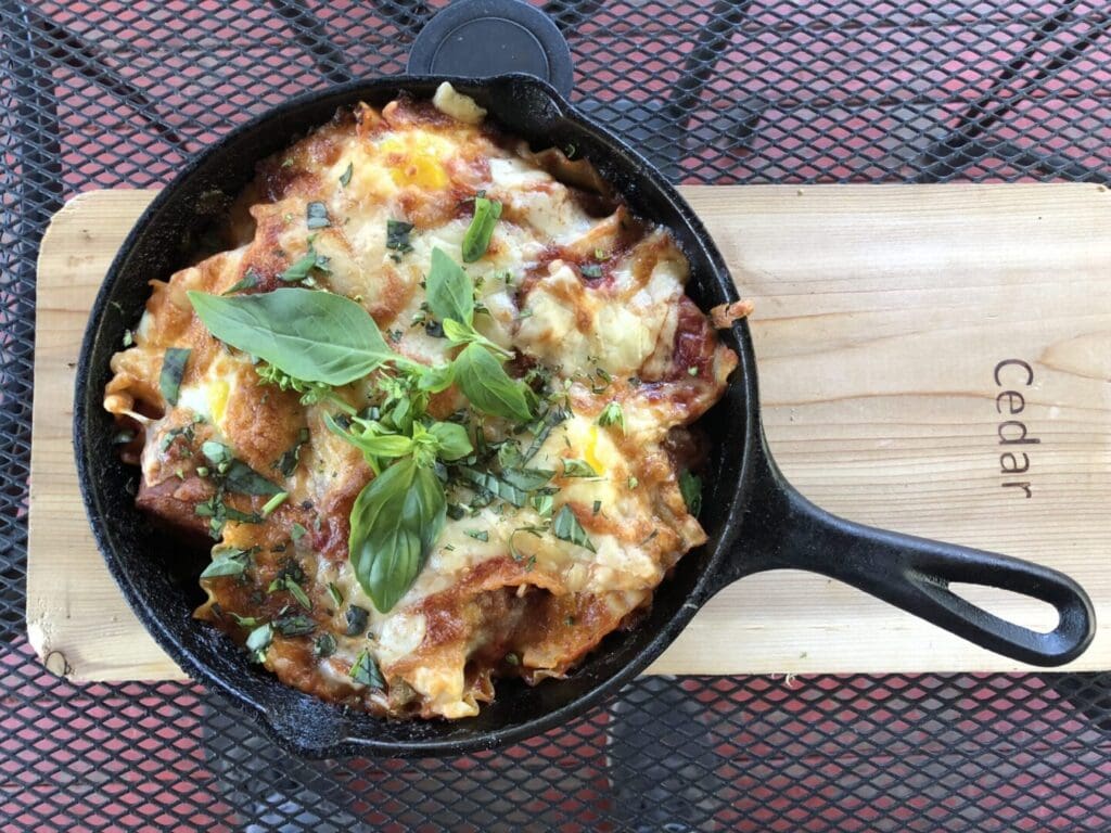 A skillet with some food in it on top of a table.
