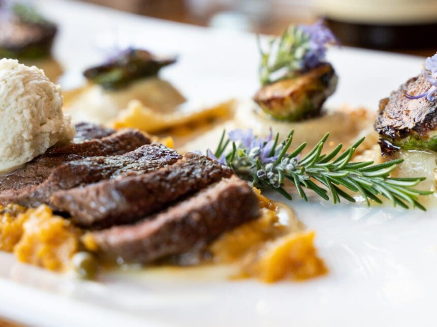 A plate of food with meat and vegetables on it.