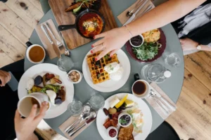 A table with plates of food and cups on it