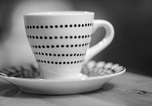 A cup of coffee on a plate with a saucer.